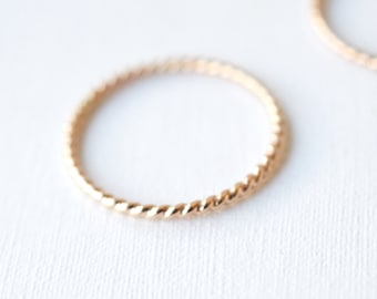 Gold stackable twist ring in 14k gold filled or 14k rose gold filled , thin pretty and dainty suitable for anniversary or wedding.