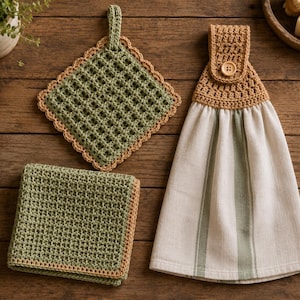 May include: A set of kitchen linens including a square sage green crocheted potholder with a tan border, a folded sage green crocheted dishcloth with a tan edge, and a white hanging kitchen towel with sage green stripes and a tan crocheted top.