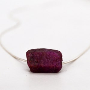 This natural raw Ruby necklace is a perfect gift for a July birthday. Ruby represents love, energy, passion, power, and a zest for life. Each is unique in shape and size. Colors range from vibrant red to purplish red.