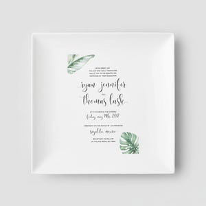 White ceramic square plate with a wedding invitation printed on it. The invitation features a tropical leaf design. Customize with any wedding invitation or other colorful keepsake.