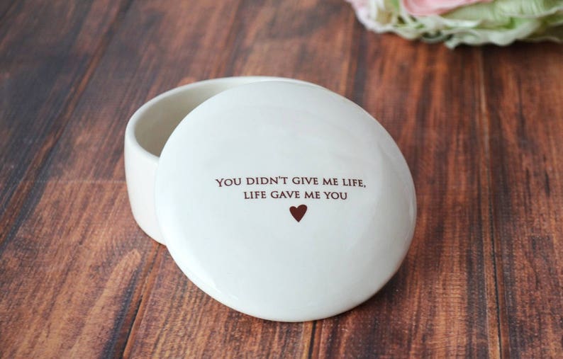 May include: White ceramic trinket box with a lid. The lid has the text "You didn't give me life, life gave me you" and a small heart.