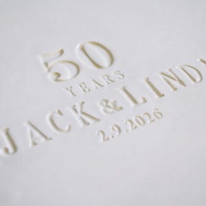A white, oval-shaped serving platter with a wavy edge. The text reads "50 YEARS JACK & LINDA 2.9.2026". The platter is an anniversary gift.