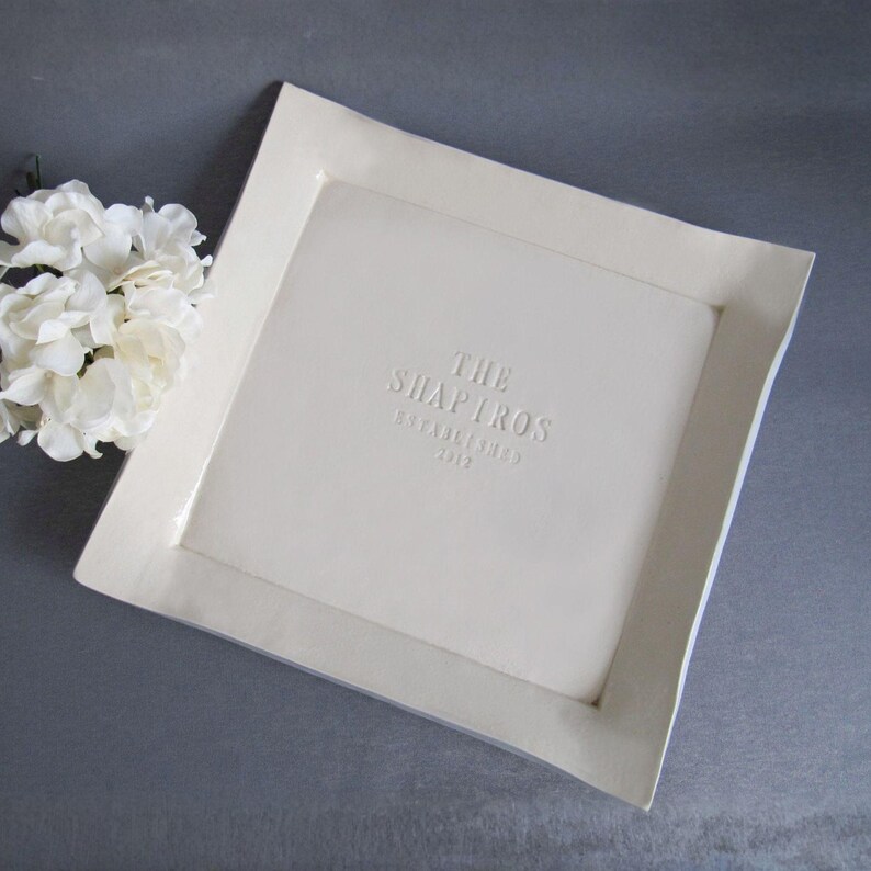 Handmade, white ceramic serving tray with a raised border and the text "THE SHAPIROS ESTABLISHED 2012" debossed in the center.