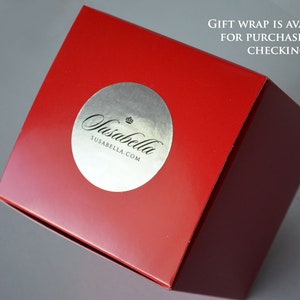 May include: A red box with a silver sticker that says "Susabella" and "susabella.com". The text "GIFT WRAP IS AVAILABLE FOR PURCHASE WHEN CHECKING OUT!" is printed on the box.