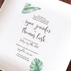 May include: Wedding invitation with a tropical theme. The invitation features a green watercolor leaf design and the text "With great joy William and Holly Hoagland invite you to celebrate the marriage of their daughter Ryan Jennifer to Thomas Lusk at 6 o'clock in the evening Friday, May 19th, 2017 Ceremony on the beach of Las Hamacas Sayulita, Mexico Reception to follow at Palapa Brisa del Mar"