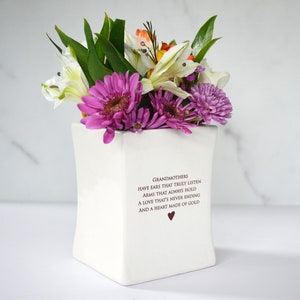 This sweet ceramic flower vase would be a perfect Christmas gift for your grandmother, grandma, or nana. It has this text on it: Grandmothers have ears that truly listen, arms that always hold, a love that's never ending and a heart made of gold.