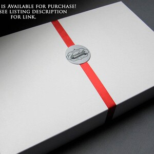 May include: A white gift box with a red ribbon and a silver sticker that says "Ansabella".