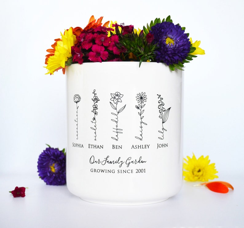 Personalized birth flower flower pot, planter, or vase is the perfect gift for Grandma, Mom, Aunt, or any loved one. The name of the birth flower is written on the stem with the family member's name underneath.