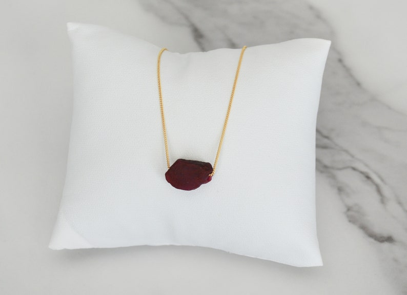 This natural raw Ruby necklace is a perfect gift for a July birthday. Ruby represents love, energy, passion, power, and a zest for life. Each is unique in shape and size. Colors range from vibrant red to purplish red.