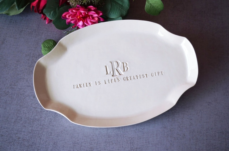 A white ceramic serving tray personalized with monogram and and the text 'Family is life's greatest gift' embossed on the surface.