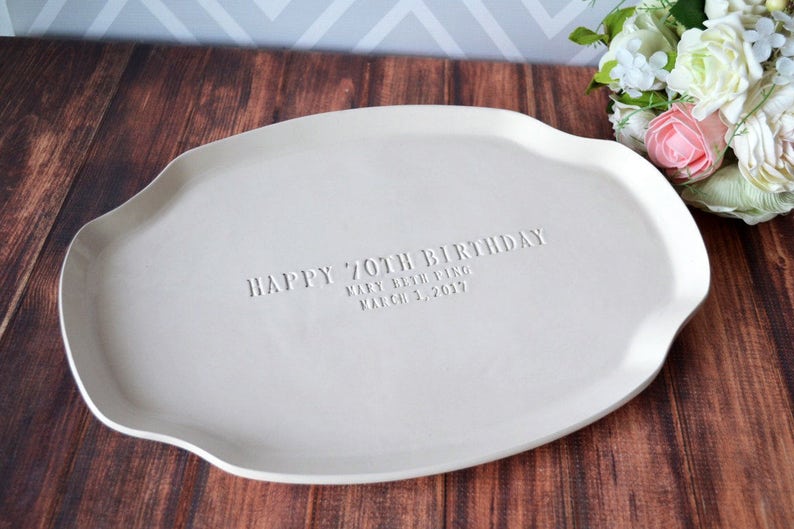 celebrate birthday milestones with handmade ceramic stamped platter. hand-stamped with happy 70th birthday. personalize to your name and date.