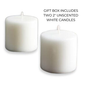 May include: Two white unscented pillar candles, each measuring 2 inches in diameter.  Gift box includes two 2" unscented white candles.