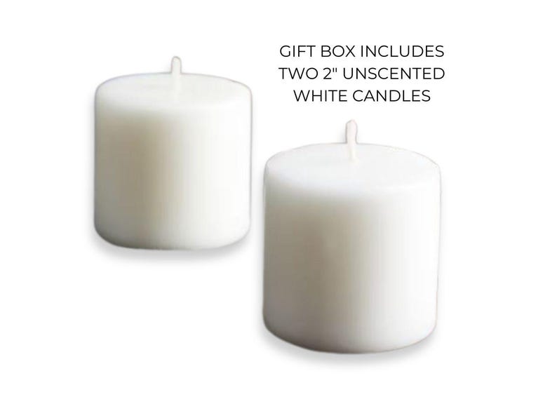 May include: Two white unscented pillar candles, each measuring 2 inches in diameter.  Gift box includes two 2" unscented white candles.