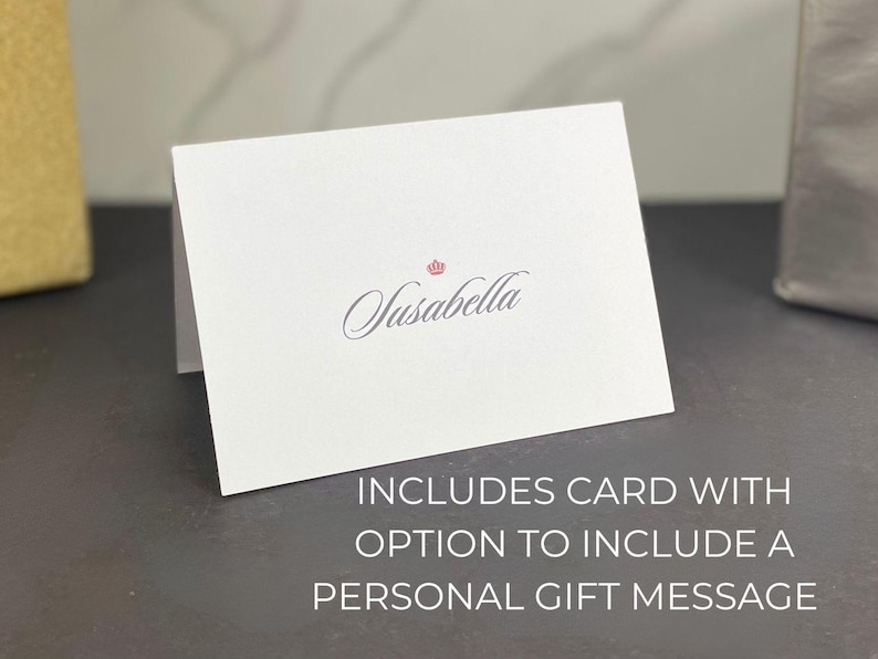 May include: White card with the text "Susabella" in cursive script and a small crown above the text. The card includes the text "INCLUDES CARD WITH OPTION TO INCLUDE A PERSONAL GIFT MESSAGE".