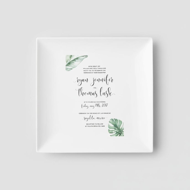 White ceramic square plate with a wedding invitation printed on it. The invitation features a tropical leaf design. Customize with any wedding invitation or other colorful keepsake.