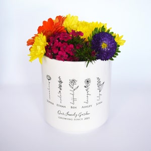 Personalized birth flower flower pot, planter, or vase is the perfect gift for Grandma, Mom, Aunt, or any loved one. The name of the birth flower is written on the stem with the family member's name underneath.