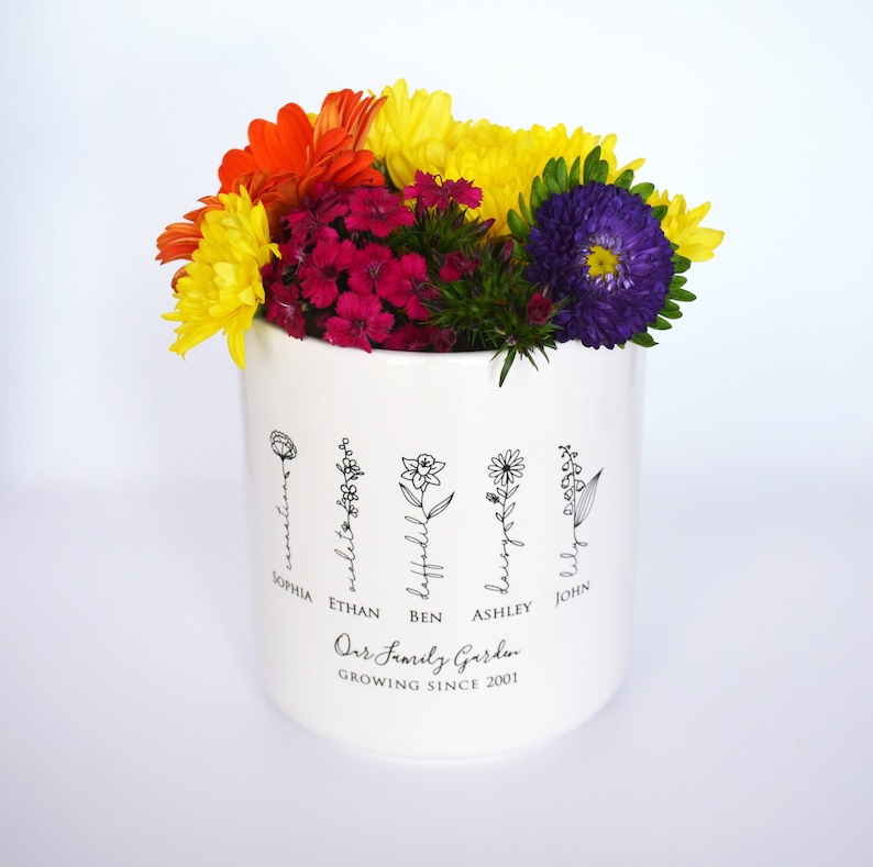 Personalized birth flower flower pot, planter, or vase is the perfect gift for Grandma, Mom, Aunt, or any loved one. The name of the birth flower is written on the stem with the family member's name underneath.