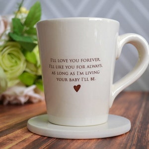 This sweet ceramic mug would be a perfect Mothers Day gift. It's made of earthenware clay and has this text printed on it: I'll Love You Forever, I'll Like You for Always, As Long as I'm Living Your Baby I'll Be.