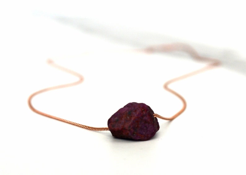 This natural raw Ruby necklace is a perfect gift for a July birthday. Ruby represents love, energy, passion, power, and a zest for life. Each is unique in shape and size. Colors range from vibrant red to purplish red.