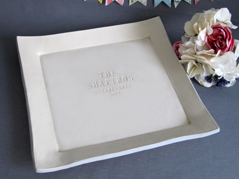 White ceramic serving tray with a raised border and the text "THE SHAPIROS ESTABLISHED 2012" embossed in the center.