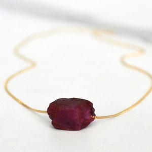 This natural raw Ruby necklace is a perfect gift for a July birthday. Ruby represents love, energy, passion, power, and a zest for life. Each is unique in shape and size. Colors range from vibrant red to purplish red.