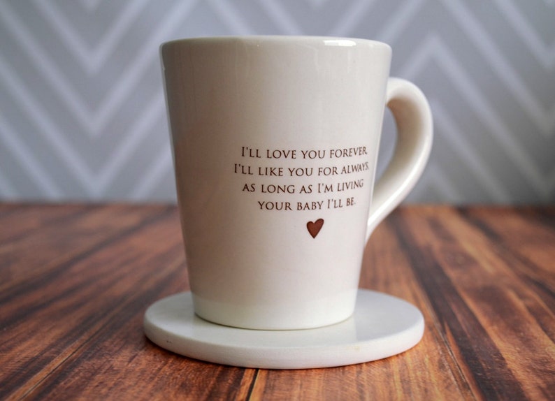 This sweet ceramic mug would be a perfect Mothers Day gift. It's made of earthenware clay and has this text printed on it: I'll Love You Forever, I'll Like You for Always, As Long as I'm Living Your Baby I'll Be.