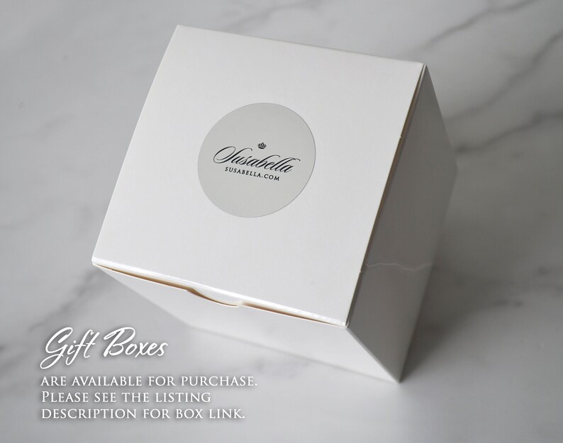 May include: A white square gift box with a round sticker featuring the text "Susabella" and "SUSABELLA.COM". The box is on a white marble surface. Text on the image reads "Gift Boxes ARE AVAILABLE FOR PURCHASE. PLEASE SEE THE LISTING DESCRIPTION FOR BOX LINK."