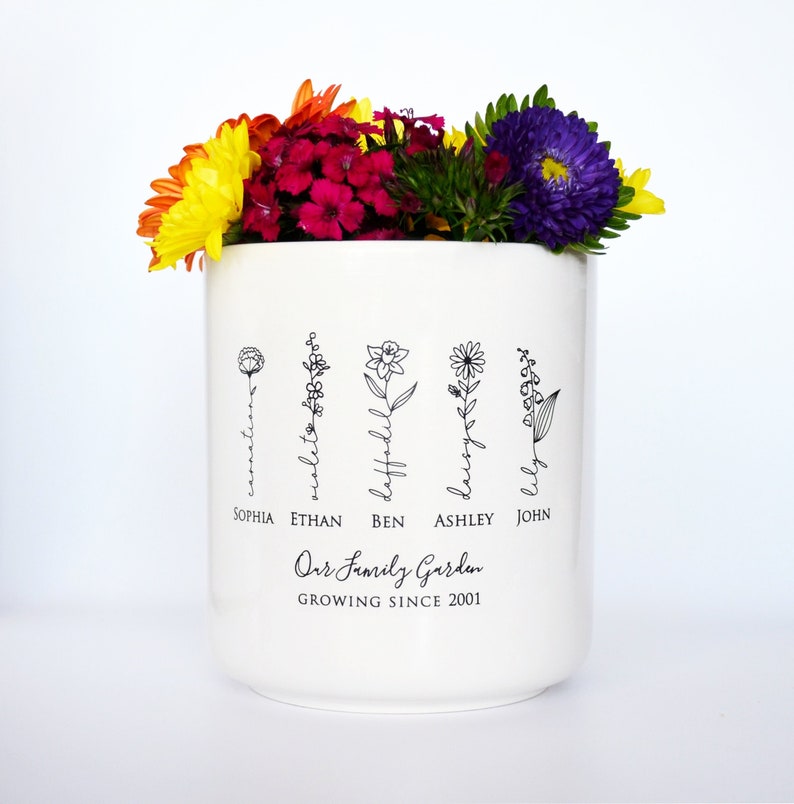 Personalized birth flower flower pot, planter, or vase is the perfect gift for Grandma, Mom, Aunt, or any loved one. The name of the birth flower is written on the stem with the family member's name underneath.