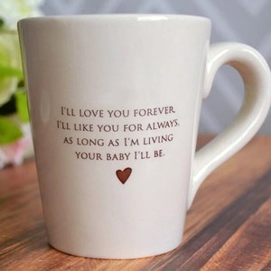 This sweet ceramic mug would be a perfect Mothers Day gift. It's made of earthenware clay and has this text printed on it: I'll Love You Forever, I'll Like You for Always, As Long as I'm Living Your Baby I'll Be.