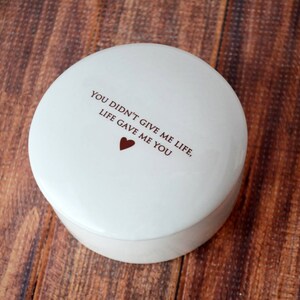 May include: White ceramic trinket box with the text "You didn't give me life, life gave me you" and a small red heart.