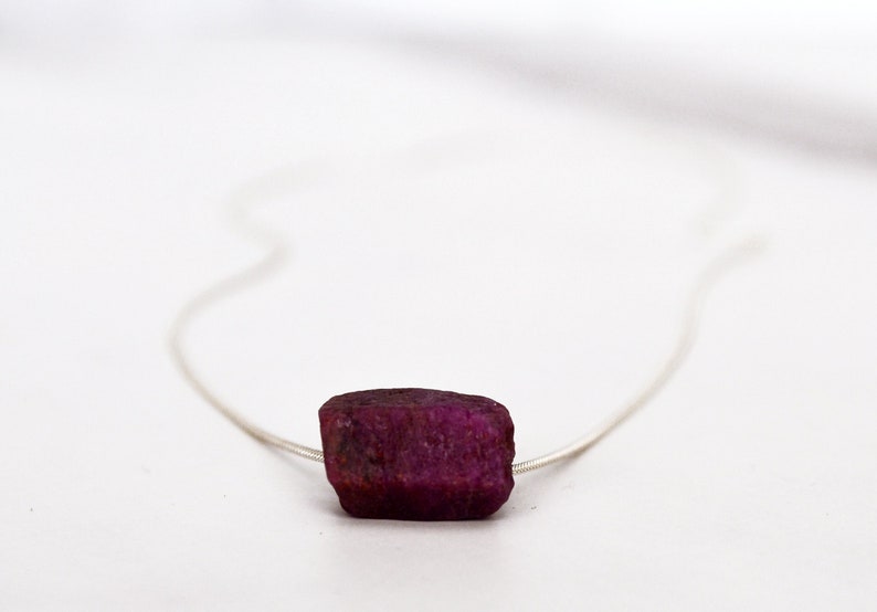 This natural raw Ruby necklace is a perfect gift for a July birthday. Ruby represents love, energy, passion, power, and a zest for life. Each is unique in shape and size. Colors range from vibrant red to purplish red.