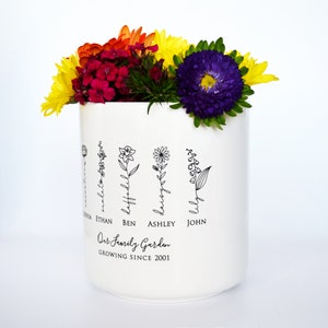 Personalized birth flower flower pot, planter, or vase is the perfect gift for Grandma, Mom, Aunt, or any loved one. The name of the birth flower is written on the stem with the family member's name underneath.