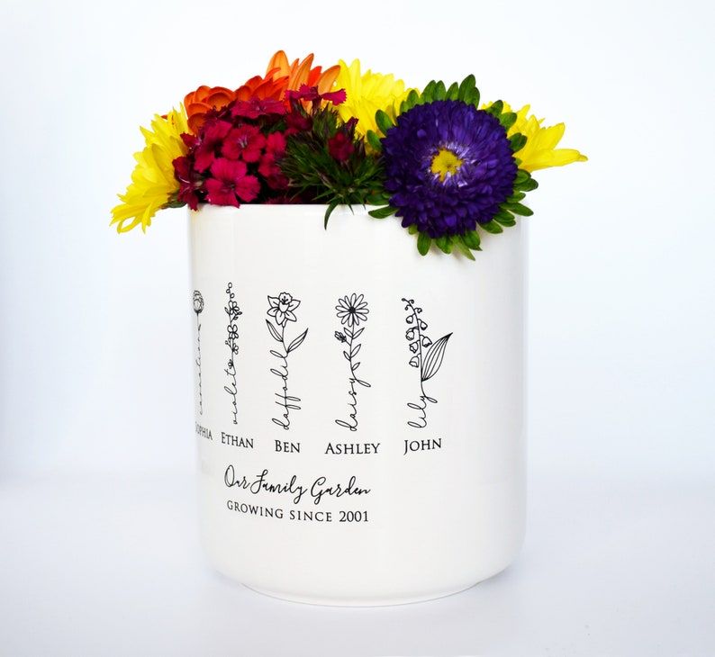 Personalized birth flower flower pot, planter, or vase is the perfect gift for Grandma, Mom, Aunt, or any loved one. The name of the birth flower is written on the stem with the family member's name underneath.