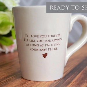 This sweet ceramic mug would be a perfect Mothers Day gift. It's made of earthenware clay and has this text printed on it: I'll Love You Forever, I'll Like You for Always, As Long as I'm Living Your Baby I'll Be.