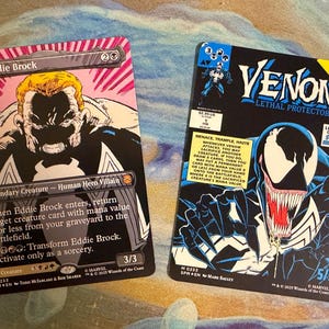May include: Two collectible trading cards featuring Marvel characters. The left card shows Eddie Brock with pink background accents. The right card displays Venom from the Lethal Protector comic series, including text, game stats, and a 5/5 power rating.