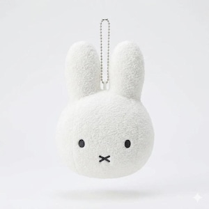 May include: A white plush rabbit head keychain featuring a soft, fuzzy texture, two upright ears, and a simple embroidered face with two black circular eyes and a black cross-shaped mouth. A silver-toned metal ball chain is attached to the top.