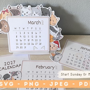 May include: A 2027 desk calendar set featuring illustrated cat faces around the borders. The March page is displayed upright, showing a grid with dates from 1 to 31. Additional pages for January and February are visible, along with text indicating file formats SVG, PNG, JPEG, and PDF.