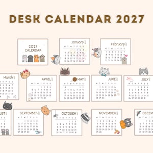 May include: A 2027 desk calendar featuring twelve monthly pages with black text and numbers. Each month displays a unique cartoon cat illustration, including cats with hats, yarn, pumpkins, and holiday accessories, set against a light cream background.