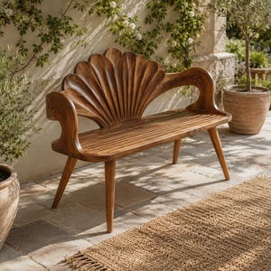 May include: A wooden bench featuring a backrest carved into the shape of a large, fanned seashell. The seat consists of horizontal slats, and the frame is supported by four tapered legs, showcasing a natural brown wood grain throughout the piece.