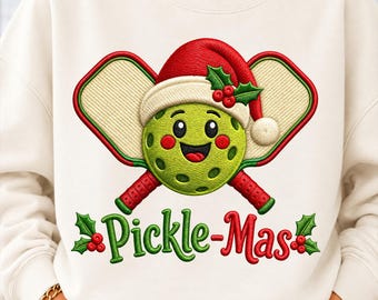 May include: A cream-colored sweatshirt featuring an embroidered graphic of a smiling green pickle ball wearing a red Santa hat, positioned in front of two crossed pickleball paddles. The text "Pickle-Mas" is embroidered below with holly accents.