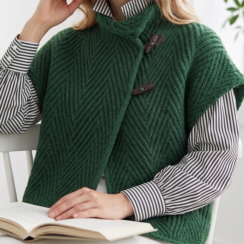 Woman wearing an oversized olive green herringbone knit vest with high collar
Textured knit waistcoat featuring decorative toggle buttons and sleeveless design
Modern knitted vest with herringbone stitch pattern and oversized silhouette
Warm merino wool vest layered over a long sleeve top with structured collar
Elegant button front knit vest featuring textured fabric and relaxed fit