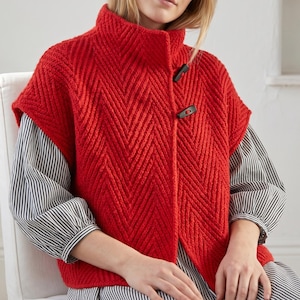 Woman wearing an oversized olive green herringbone knit vest with high collar
Textured knit waistcoat featuring decorative toggle buttons and sleeveless design
Modern knitted vest with herringbone stitch pattern and oversized silhouette
Warm merino wool vest layered over a long sleeve top with structured collar
Elegant button front knit vest featuring textured fabric and relaxed fit
