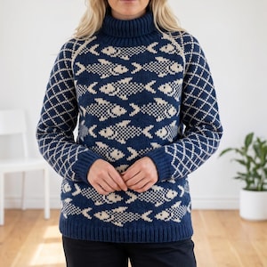 May include: A navy blue turtleneck sweater featuring a repeating cream-colored fish pattern across the torso and a diamond-shaped grid pattern on the sleeves. The garment has a ribbed collar, cuffs, and hem, constructed with a knit texture.