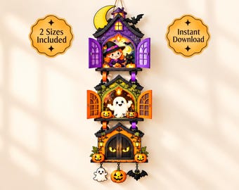 May include: A vertical three-tiered Halloween wall hanging featuring a purple house with a witch and cat, a green house with a ghost, and an orange house with glowing eyes. Includes hanging charms of a ghost, pumpkin, and bat. Text reads 2 Sizes Included.