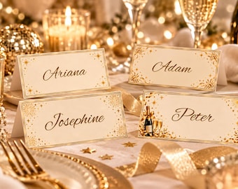 May include: Four rectangular white place cards with gold foil borders and starburst accents. The cards feature the names Ariana, Adam, Josephine, and Peter in elegant black script. One card includes a small illustration of a champagne bottle.