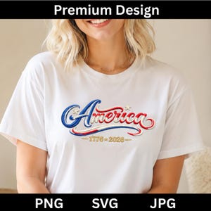 May include: A white short-sleeved t-shirt featuring an embroidered graphic of the word America in blue and red script with two small stars. Below the text, the gold numbers 1776 and 2026 are separated by a star, creating a patriotic design.