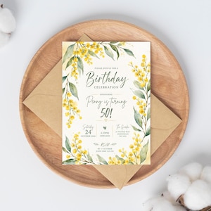 May include: A rectangular birthday invitation card featuring watercolor illustrations of yellow mimosa flowers and green leaves along the sides. The text reads: Please join us for a Birthday Celebration honouring Penny is turning 50! Saturday 24 October 2026.