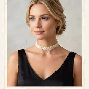 May include: An ivory crochet lace choker featuring a scalloped edge and small pearl accents. The piece is labelled as THE AURORA LACE CHOKER, Handmade Crochet Lace with Pearl Details - Ivory. The design consists of a delicate woven pattern.