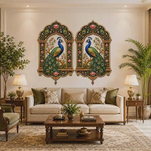 May include: Two identical wall art panels featuring a vibrant peacock perched on a branch, framed by an ornate archway with floral motifs in shades of gold, green, and blue. The detailed illustrations are set against a light-colored wall.