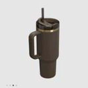 May include: A dark brown insulated tumbler with a matching handle, a black lid, and a black straw. The cylindrical container features a metallic gold-toned ring accent just below the lid, providing a contrast to the matte dark brown finish.